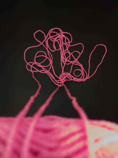 Needle  and yellow thread with black background Close up Needle  and yellow thread. Details of a thread and it can be observed its winding geometry