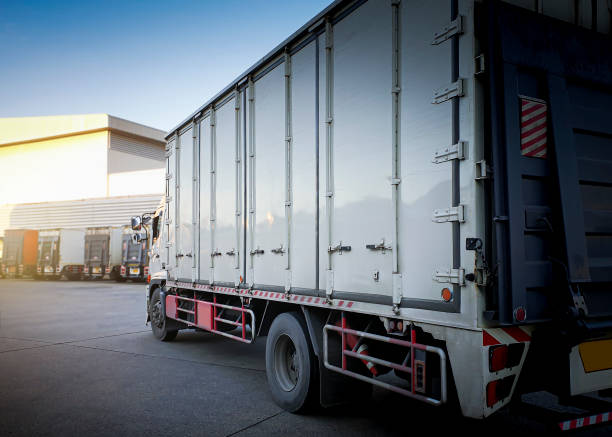 istock Cargo Trucks Parking lot with at The Warehouse. Shipping Cargo Container. Industry Freight Truck Logistics Cargo Transport. 1360778214