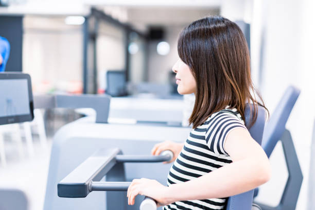 istock Young woman working out at the gym 1360778239