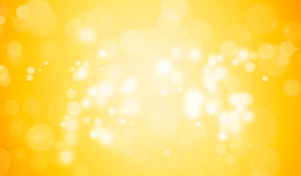 istock White Glitter Lights on Yellow or Gloden Background. White Bokeh Light Effect. Defocused, Celebration, Christmas Holiday Backdrop. 1360781763