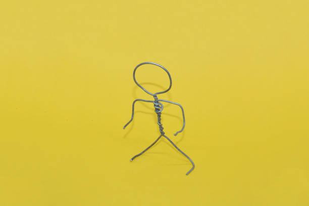 human figure made of metal wire with an object - football player imagens e fotografias de stock