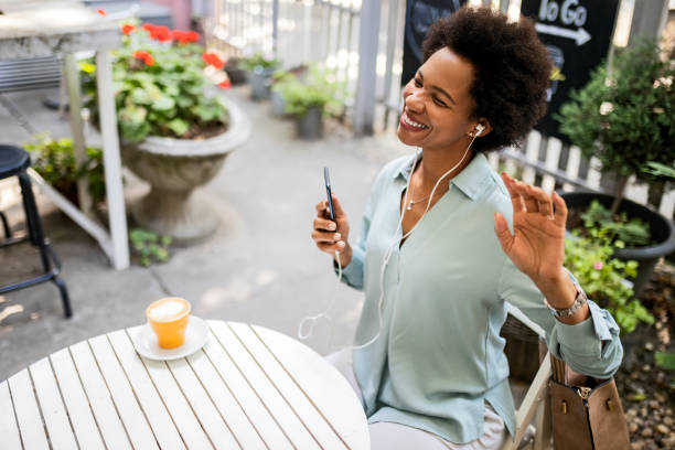 istock Young Woman drinking coffee while listening to music 1360786062