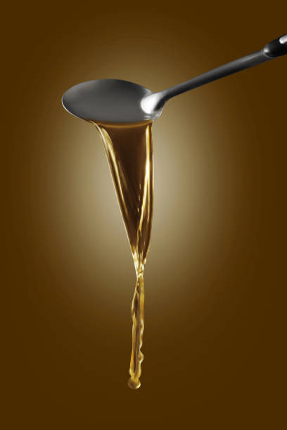 istock Dipper pouring noodle soup isolated on brown background 1360786627