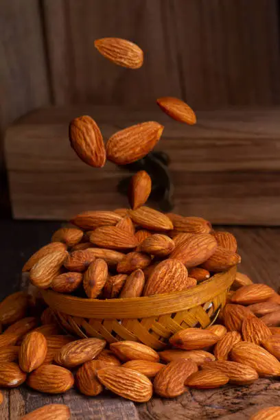 almonds isolated on wooden background. Flat lay