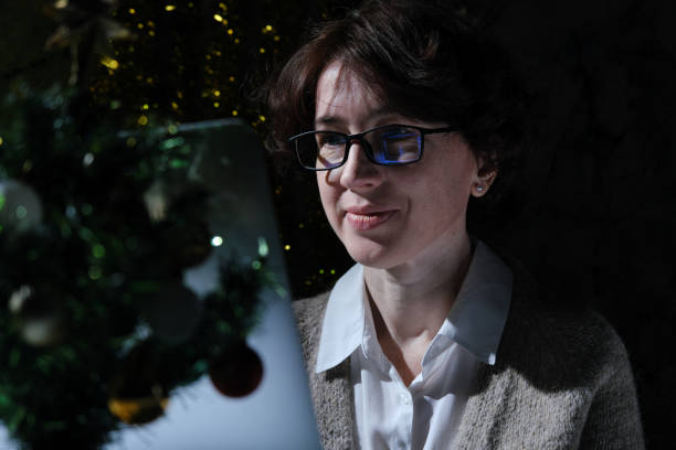 istock Woman is celebrating Christmas alone and connecting with her relatives via Internet 1360789784