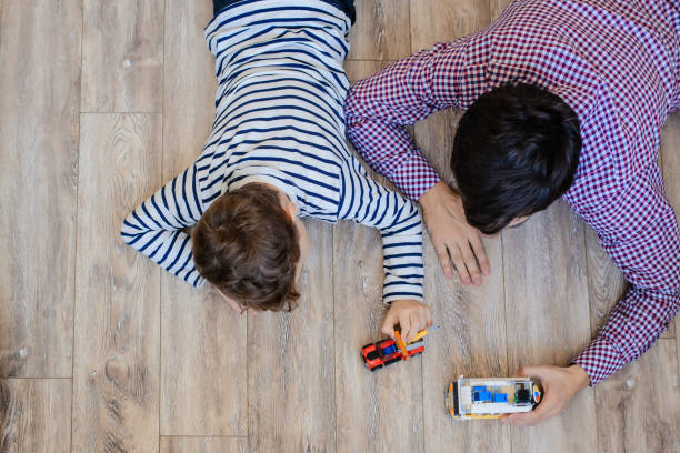 istock Top view of father and son playing with toy 1360793074