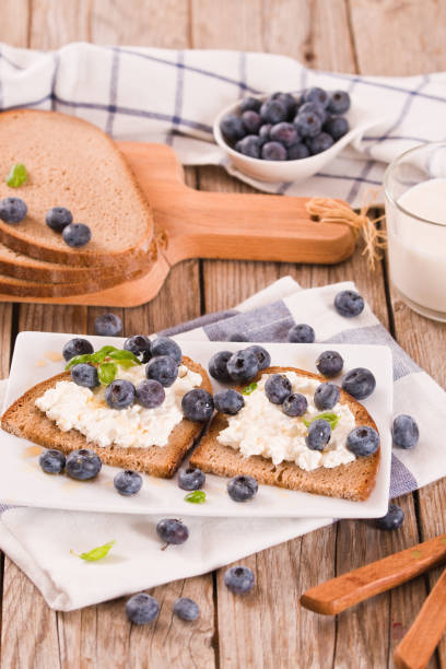 istock Rye bread with cottage cheese, blueberries and honey. 1360796314