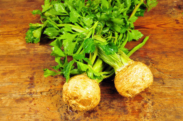 Fresh organic celery Fresh organic celery with roots on wooden table celery stock pictures, royalty-free photos & images