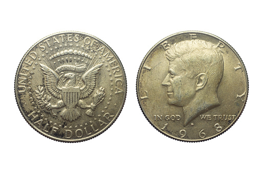 Both sides of an old US half dollar  isolated on a white background. The John F. Kennedy