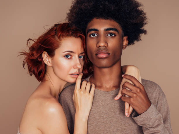 istock Interracial couple smiling and holding one another 1360797356