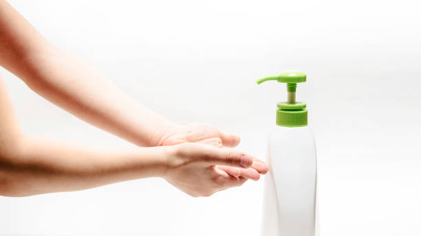 istock Man's hands on white background washing or using hands sanitizer 1360798109