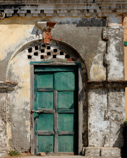 The blue door. The blue door in an unpainted house. blue front door stock pictures, royalty-free photos & images