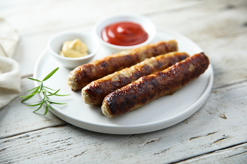 Homemade roasted sausages with ketchup and mustard
