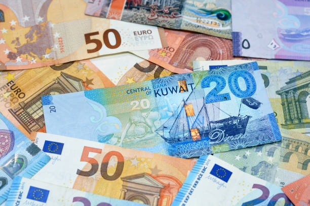 Kuwait dinars money banknote bills with European euro banknotes background Kuwait dinars money banknote bills with European euro banknotes background, selective focus of pile of Kuwaiti dinars and European euros banknotes currency exchange rates dinar stock pictures, royalty-free photos & images