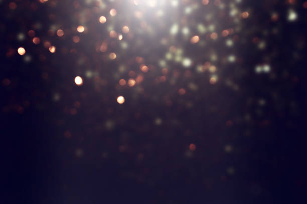 istock background of abstract gold and black glitter lights. defocused 1360802236