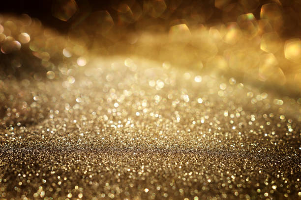 istock background of abstract gold and black glitter lights. defocused 1360803094