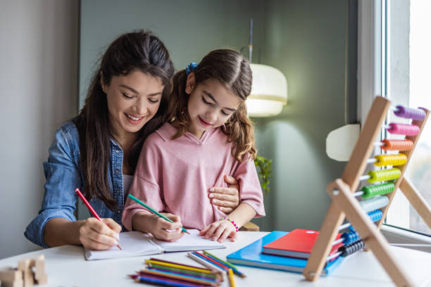 istock Writing homework with mother's assistance 1360803293