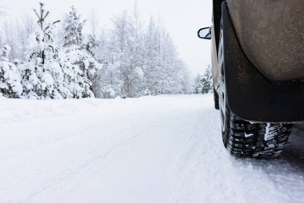istock tire on a winter snow-covered road in the forest 1360805071