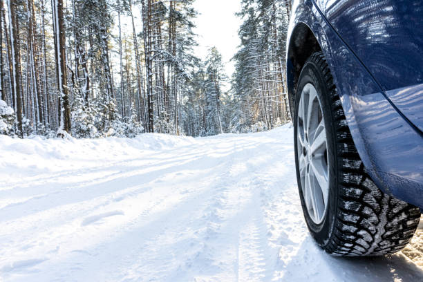 istock car on a winter road in a snowy forest 1360805081