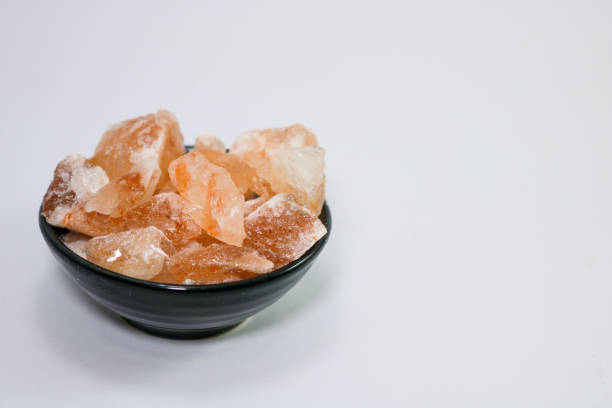 istock Pink salt on isolated white background with copy space. 1360812457