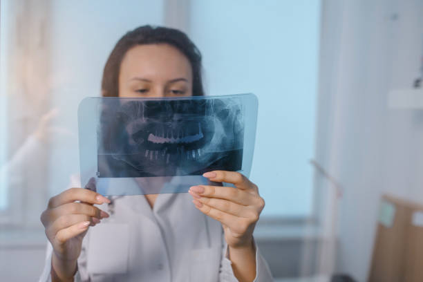 istock doctor dentist who analysis dental x ray 1360813705