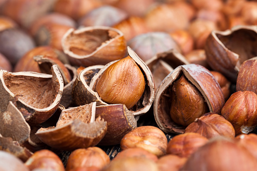 split hazelnuts on the table, split shells on raw hazelnuts during the preparation of nuts for food.