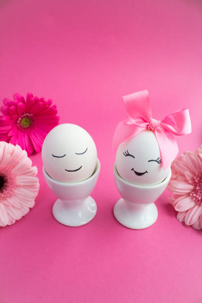 istock Easter composition with white eggs in white coasters on the pink background 1360816808