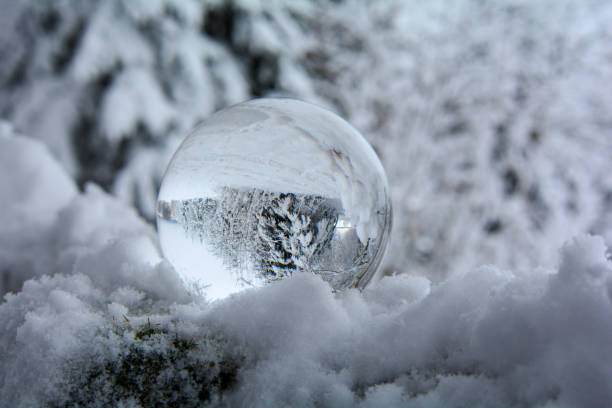 istock Glass ball in deep snow in the forest 1360818531