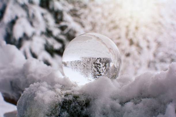 istock Snow-covered landscape is reflected in a sphere 1360818631