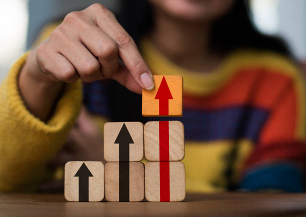istock Hand stacking wood blocks on a table with the symbol Action plan, Goal and target, success and business target idea, project management, and corporate strategy development 1360824387