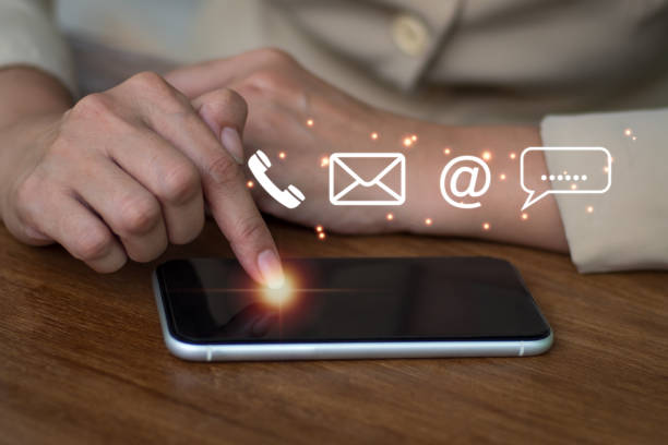 istock Business lady using smart phone with email, phone, address, and chat message icons.Customer service phone number. Contact us people connection. 1360824393