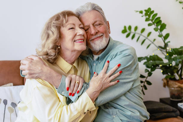 istock Senior couple is embracing at home 1360824513