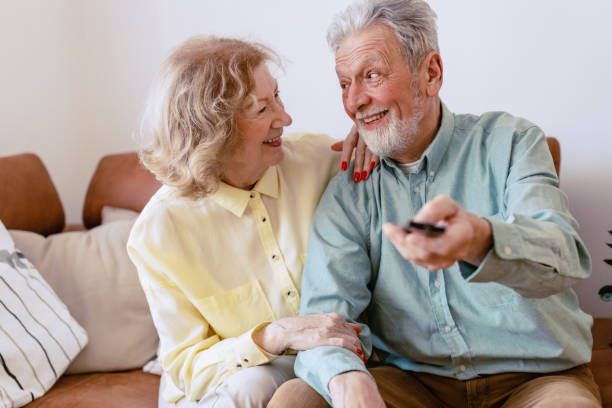 istock Senior couple at home watching TV 1360824646