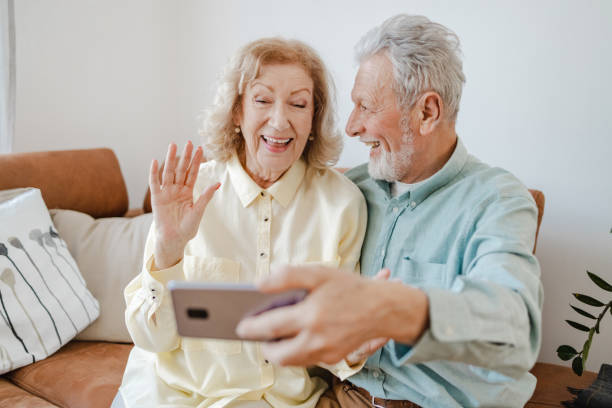 istock Lovely senior couple taking selfie at home 1360825832