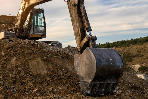 istock The Excavator is digging a construction site hole for future building. 1360827308