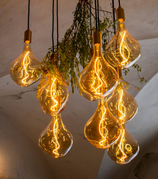 istock Decorative antique edison style filament light bulbs hanging from the ceiling. 1360828327