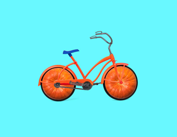 istock An orange bicycle with pumpkin-shaped wheels on a blue background. 1360831240
