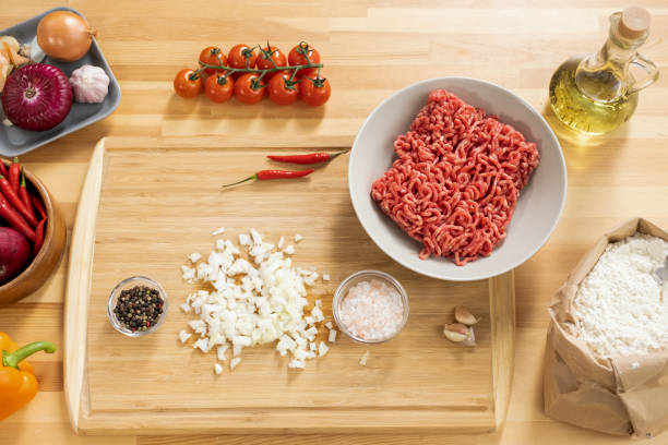 istock Flatlay of fresh vegetables and minced meat on wooden kitchen table 1360832012