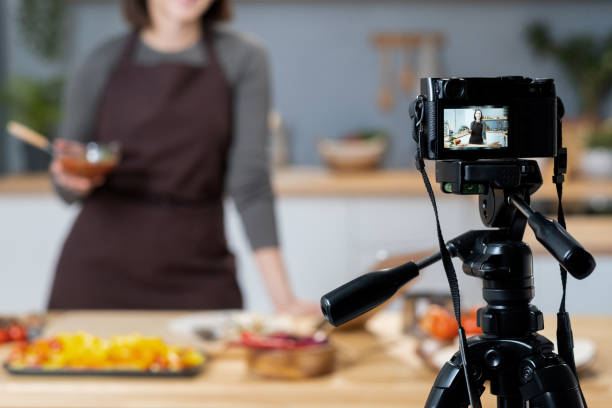 istock Young female blogger giving cooking masterclass in front of video camera 1360832026