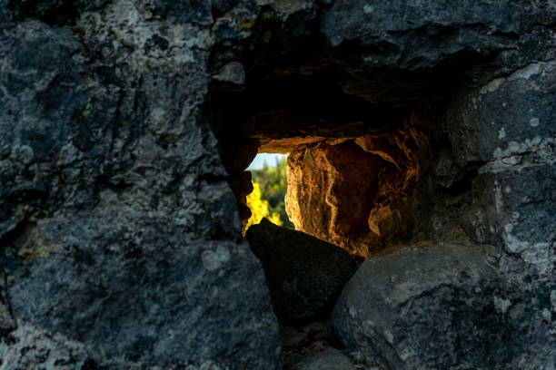 hole in a stone wall through which the solar outside world is visible