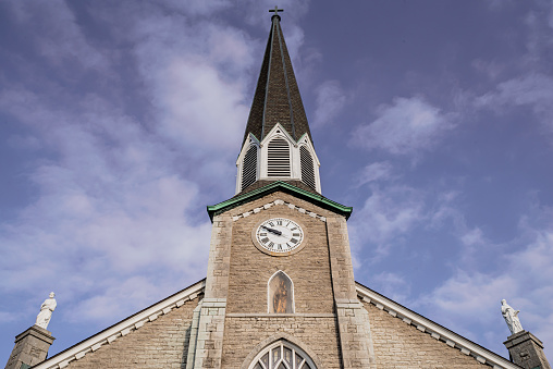 Spire, clock and front elevation of a Roman Catholic church - Saints Peter and Paul - in Williamsville, NY.