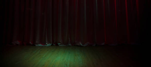 istock Green dark stage floor and dark purple curtains. 1360833893
