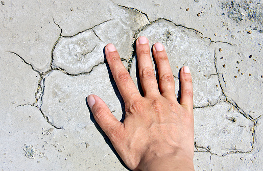 Hands forming a cone in sand