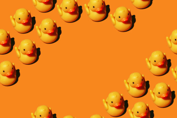 istock Seamless pattern: yellow rubber toy duck isolated on orange background; with copyspace 1360839030