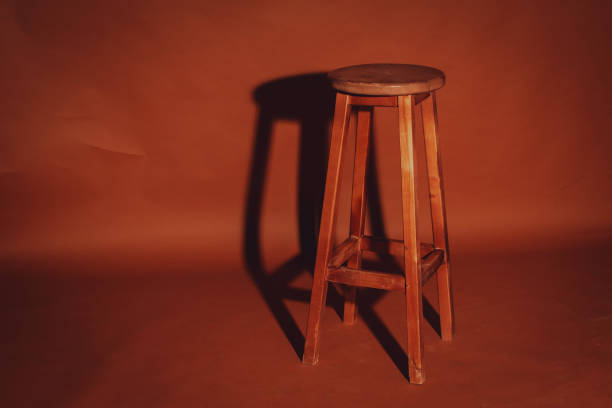 istock Wooden stool isolated on brown paper background 1360839037