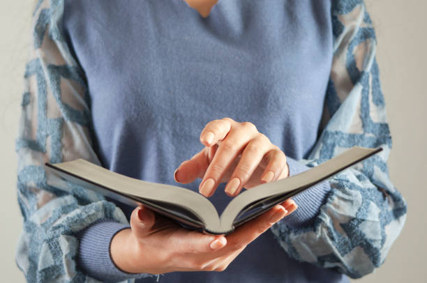 istock young woman reading Holy Bible 1360840227