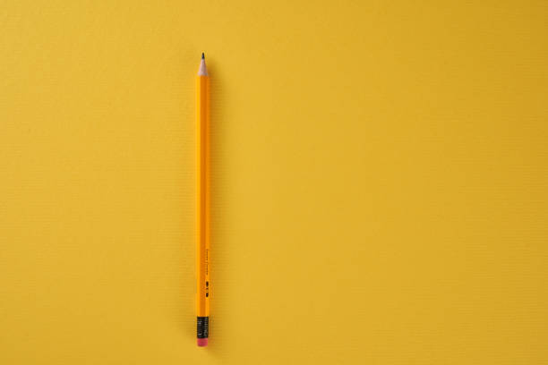 istock yellow pencil on yellow background 1360842092