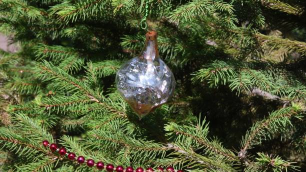 istock Retro holiday decoration on natural conifer tree in sunny day 1360842814