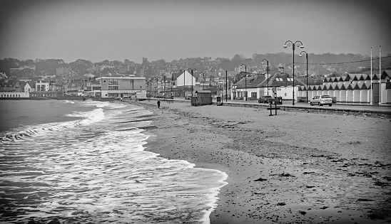 A black and white treatment of Swanage beach on a winter rainy day made to look like an old postcard