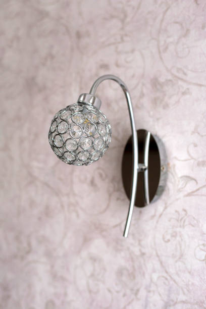istock Round sconce made of crystals on pink wall 1360845819
